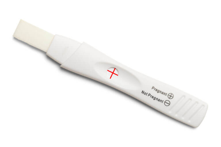 Positive White Plastic Pregnancy Test Isolated on White Background.