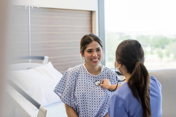 Young adult woman smiles at the Doctor