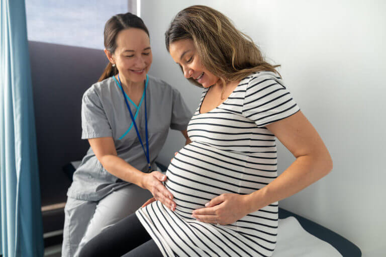 Expectant mother talking to midwife