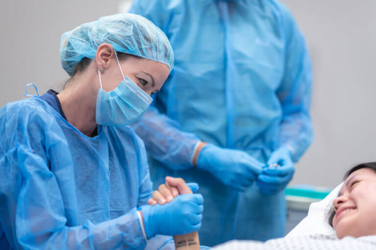 GYN doctor holding hands of the patient