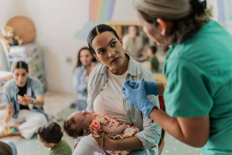 Mature mother learning to care for her newborn daughter during a Prenatal Care visit.